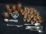 a lot of glasses and silverware on the table