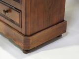 a wooden dresser with three drawers on top of it