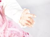 a baby doll that is wearing a pink dress and a white shirt