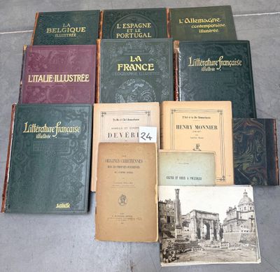 several books on a table with a lot of them sitting on the floor