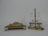 two glass vases and a candle holder on a table