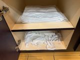 a white towel sitting on top of a shelf in a bathroom