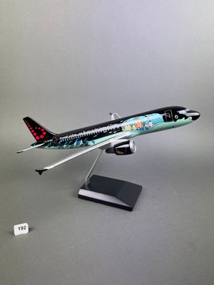 a model of a plane on a stand on a gray surface
