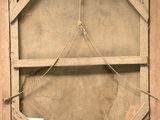 a picture of an old window with a chain hanging from it