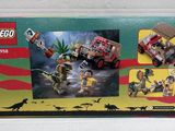 a box of legos with a picture of dinosaurs and a car