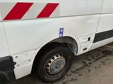 a white van with red stripes parked on the side of the road