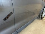a car with a sticker on the side of it ' s door