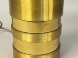 brass plated cup with a handle and a handle on a white surface