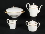 four pieces of white and gold tea and coffee set on a black background
