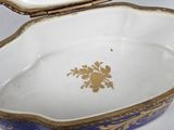 a blue and white bowl with a gold decoration on it