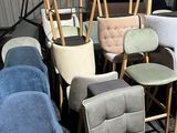 many chairs and stools that are sitting in a room