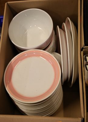 a lot of plates and bowls in a box