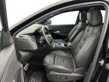 the interior of a car with the door open and the driver ' s seat down