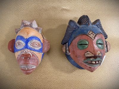 two masks that are sitting on a table