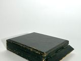 a black book sitting on top of a white table