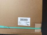 a cardboard box with a green ribbon on top of it