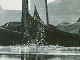 a boat that is floating in the water near a building