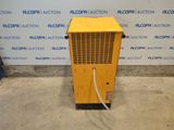 a yellow air conditioner sitting in front of a wall