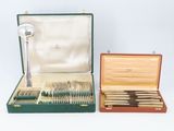 a green case with silverware in it and a silver spoon in it