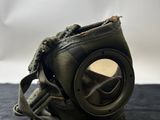 a gas mask that is on a black surface