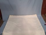 a white sheet sitting on top of a blue chair