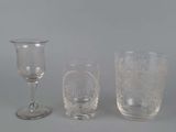 three wine glasses sitting next to each other on a table
