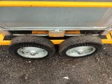 two wheels on a cart that are sitting on the ground