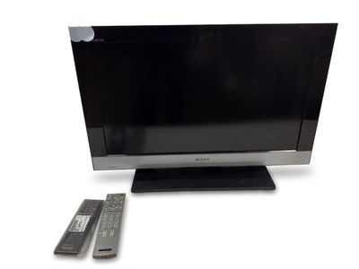 a flat screen tv sitting on a stand next to a remote control