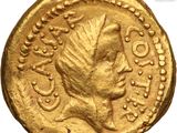 a close up of a gold coin with a woman on it
