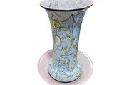 a blue and white vase sitting on a saucer