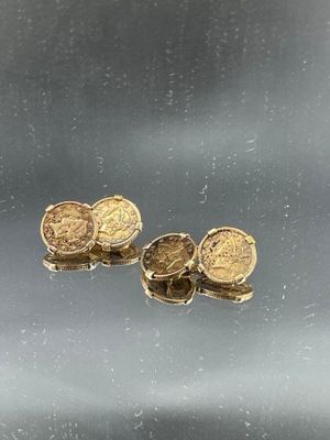 two gold coins sitting on top of each other
