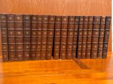 several old books are lined up on a wooden table