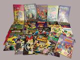 a lot of comic books that are on the table