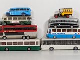 a lot of toy buses that are stacked on top of each other
