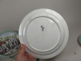 a person holding a white plate with a picture on it
