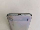 the back of a phone with a broken screen sitting on a table