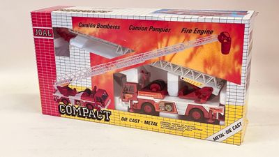 a box with a toy fire truck and a fire engine