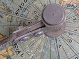 a close up of a clock on a map of the world