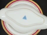 a white plate with a blue triangle on it on a black table
