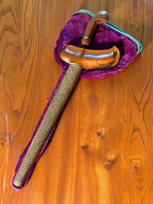 a wooden spoon with a wooden handle on a wooden table