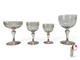 three empty wine glasses sitting next to each other on a white surface