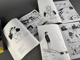 several pages of comics are spread out on a table