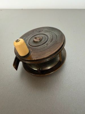a small metal object with a yellow handle on a table