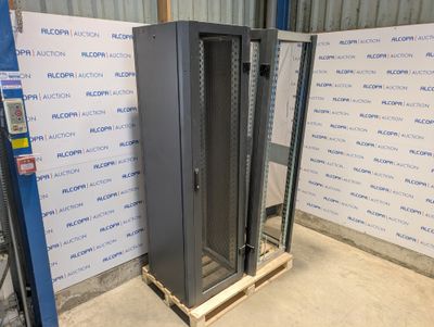 a large metal rack in a warehouse with a blue wall behind it