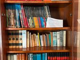 a book shelf with many books on it in a room