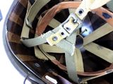 a close up of a helmet with a belt on it