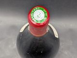 a bottle of wine that is sitting in a sink