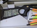 a box with a gun, arrows, and other items in it
