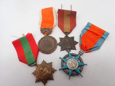 several medals and medals are arranged on a white surface