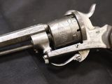 a gun that is on display on a black surface